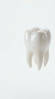 White ceramic tooth model with cavity on clean background for dental education and healthcare presentations.