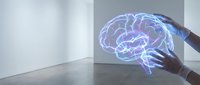 Human hand touching glowing holographic brain projection in modern interior space showcasing artificial intelligence and neuroscience technology concepts.