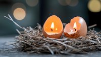 Glowing candles in eggshells nestled in natural straw nest with soft bokeh background create cozy atmospheric Easter or spring decoration.