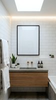 Modern bathroom interior with white subway tile walls, floating wooden vanity with concrete countertop, blank framed poster, potted plants, and skylight for home decor and design inspiration.