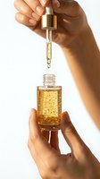 Woman hands holding luxury golden face serum with dropper bottle for skincare routine and anti-aging treatment on white background.