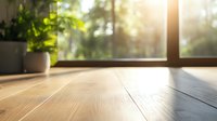Sunlit wooden floor with potted plants by window creating cozy morning atmosphere. Natural light streaming through glass adds warmth to minimalist home interior space.