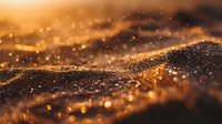 Abstract golden landscape with water droplets and bokeh effect creating magical glowing texture in warm amber tones at sunset.