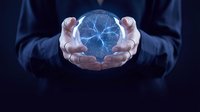 Businessman in dark suit holding glowing digital brain sphere with neural network connections, representing artificial intelligence, technology innovation, and future computing solutions.