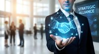 Professional businessman displaying holographic handshake symbol representing strategic alliance and partnership in modern corporate environment.