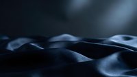 Abstract dark fabric waves with soft lighting creating dramatic shadows and highlights for luxury textile design backgrounds.