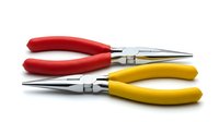 Two long-nose pliers with red and yellow rubber handles on white background, isolated chrome hand tools for repair and electrical work.