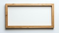 Empty wooden picture frame with natural oak finish against white wall background, ready for artwork or photography display.