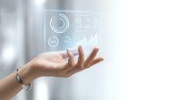 Hand displaying holographic data visualization interface with charts and analytics in modern digital technology concept for business presentations.