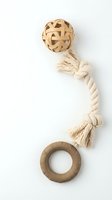 Natural pet toys set isolated on white: woven rattan ball, knotted cotton rope, and rubber ring for dogs or cats, eco-friendly design.