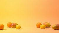 Assorted fresh citrus fruits and mangoes arranged on warm gradient background, suitable for food, nutrition, and healthy lifestyle content.