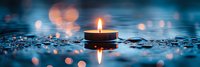 Burning candle floating on water surface with bokeh lights creating peaceful atmosphere. Reflection creates symmetrical composition in dark blue tones.