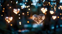 Glowing heart-shaped fairy lights create romantic bokeh effect against dark background, magical evening atmosphere for weddings and celebrations.