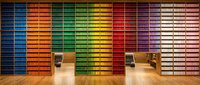 Colorful rainbow storage wall with organized filing cabinets and drawers in modern office interior design for workspace organization and productivity.