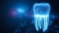Digital tooth hologram with glowing blue wireframe structure and light particles on dark background for dental technology and healthcare innovation concepts.