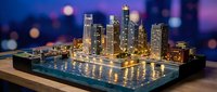 Miniature city skyline model with glowing lights on a wooden surface, bokeh cityscape background at dusk, urban architecture scale model.