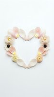 Heart-shaped floral arrangement with pink tulip petals and cream ranunculus flowers on white background for romantic wedding or Valentine's Day designs.
