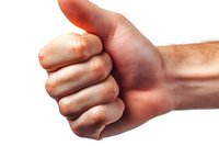 Male hand showing thumbs up gesture against white background, close-up view of positive approval sign with natural skin texture and lighting.