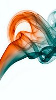 Abstract colorful smoke swirls in orange and teal creating fluid motion patterns on white background for modern design projects.