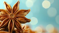 Star anise spice macro shot with soft bokeh background in turquoise and gold tones, aromatic ingredient for seasonal cooking and holiday baking.