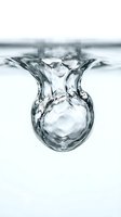 Dynamic water droplet suspended mid-fall with crystalline splash formation, isolated on white background. Suitable for beverage, wellness, and environmental design projects.