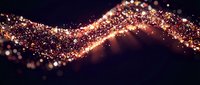 Golden glitter wave flowing across dark background with sparkling particles and bokeh lights creating magical luminous trail for luxury design projects.