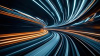 Dynamic light trails creating futuristic tunnel effect with glowing blue and orange streaks against dark background, conveying speed, motion and technology advancement.