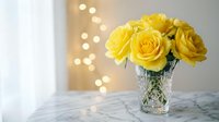 Fresh yellow roses in crystal vase on marble surface with warm bokeh lights creating elegant home decor atmosphere for romantic occasions and celebrations.