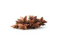 Star anise pods arranged on white background, aromatic spice ingredient for cooking and flavoring, isolated culinary element for design use.