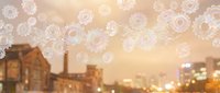 Bokeh gears floating over blurred industrial cityscape at sunset, representing technology, innovation, and urban progress for business and industrial design projects.