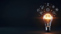 Glowing light bulb with brain inside surrounded by floating innovation icons on dark background representing creative thinking and bright ideas.