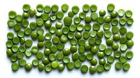 Fresh green peas scattered on white background, overhead view of organic vegetables isolated for food packaging and healthy eating concepts.