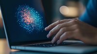 Businessman interacting with colorful digital network visualization on laptop screen, representing data analysis and technology innovation.