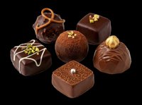 Assorted chocolate truffles and bonbons isolated on transparent background, ready for culinary design, packaging, menus, print-on-demand products, and food-related graphics.