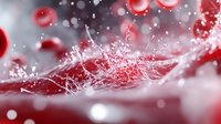 Dynamic red liquid splash with droplets and bubbles creating fluid motion against soft blurred background for beverage and refreshment concepts.
