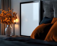 Cozy bedroom interior with blank black frame mockup, orange throw pillows, and autumn floral arrangement in vase. Soft ambient lighting creates warm atmosphere.