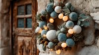 Rustic holiday wreath with yarn balls and warm LED lights on textured wall near wooden door for seasonal home decoration and festive interior design.
