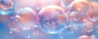 Translucent soap bubbles with iridescent reflections floating against a soft, blurred gradient background in pastel pink and blue tones, suitable for wellness and beauty designs.