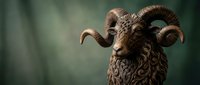 Majestic bronze ram sculpture with curved horns and detailed wool texture against soft green background for luxury decor and artistic displays.