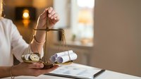 Caucasian woman holding golden justice scales with pocket watch and rolled documents, symbolizing law, time management, and legal balance.