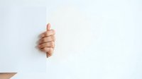 Thumbs up gesture from person with medium skin tone showing approval, success, and positive feedback on white background for business and communication concepts.