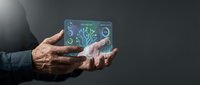 Senior businessman hands holding futuristic holographic display with digital tree and network connections representing growth and technology innovation.