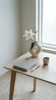 Minimalist wooden table with white lily in ceramic vase, book and cup near window. Modern Scandinavian home decor and interior design styling concept.