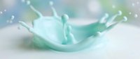 Turquoise liquid splash with dynamic droplets and waves frozen in motion against soft blurred background, suitable for cosmetics, skincare, beverage, and product advertising campaigns.