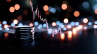 Stack of coins against blurred bokeh lights with financial market chart overlay showing downward trend, symbolizing investment risk and market volatility in dark setting.