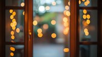 Dreamy bokeh lights through window panes create magical atmosphere with warm golden orbs against blurred background, evoking cozy evening ambiance.