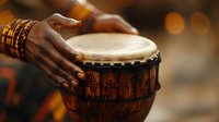 African djembe drum played by hands with traditional bracelets against warm bokeh background, capturing authentic musical performance and cultural heritage.