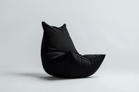 Modern black bean bag chair shaped like cat silhouette against white background, minimalist furniture design isolated for commercial and interior use.