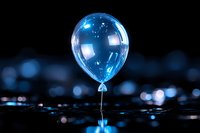 Luminous blue water drop in macro photography forming balloon shape with reflection on dark surface against blurred bokeh background. Artistic nature shot.