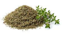 Dried thyme herb pile with fresh green thyme sprigs on white background. Culinary seasoning spice for cooking and herbal medicine applications.